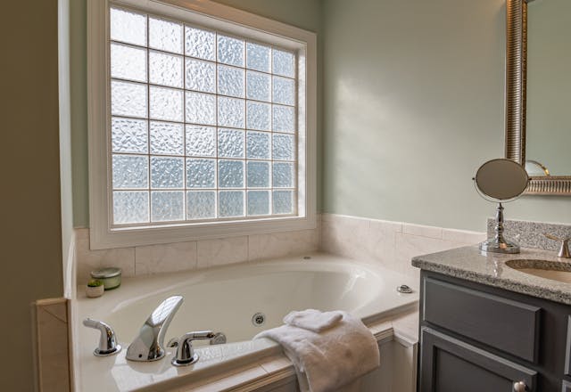 bathroom with large window and bathtub